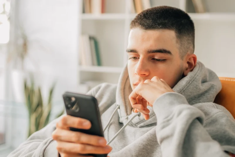 Teenage boy using mobile phone
